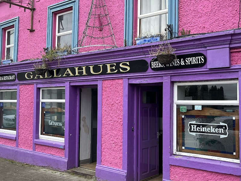 Gallahues Bar exterior, Ballylanders — bright pink and purple facade with Guinness and Heineken signs